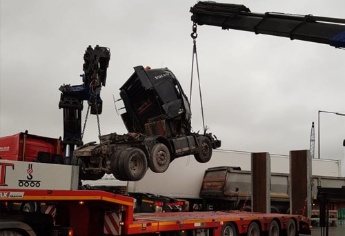 Damaged Truck being lowered onto GKT trailer for removal